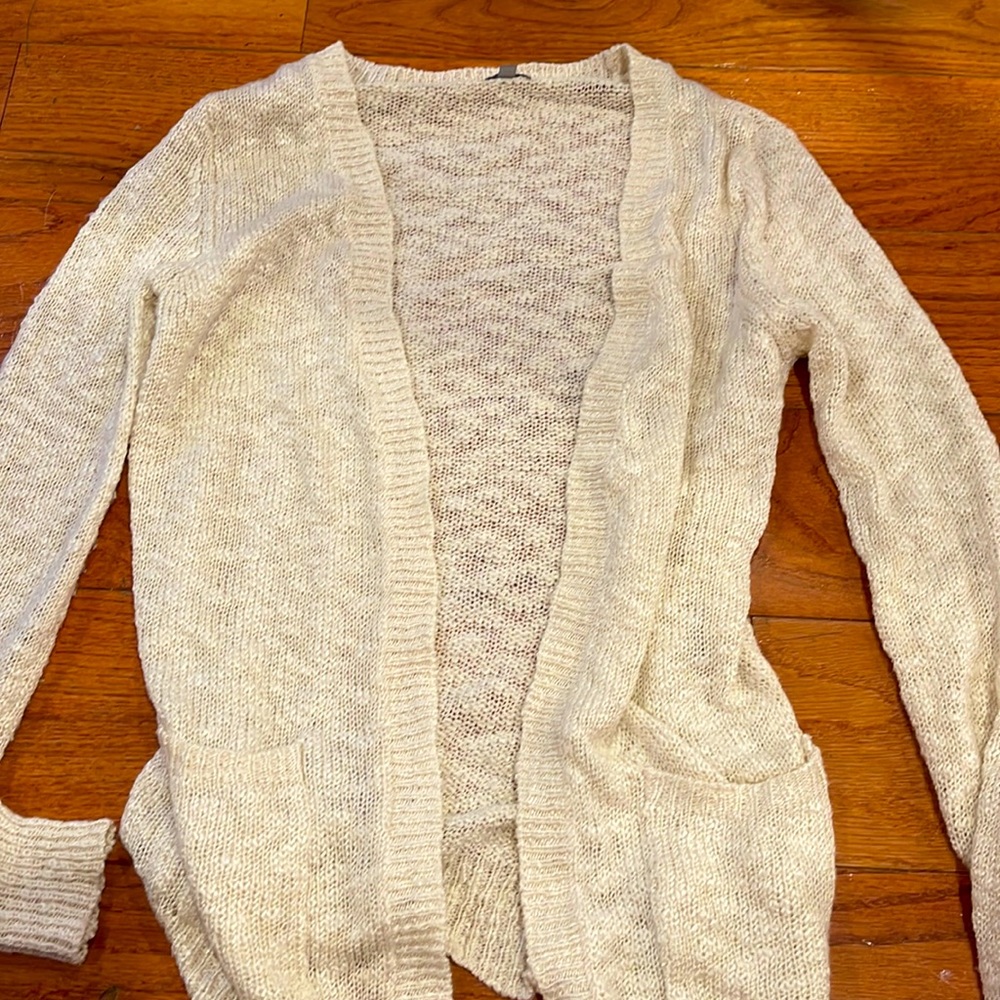 It’s a cream/ a little yellow cardigan.